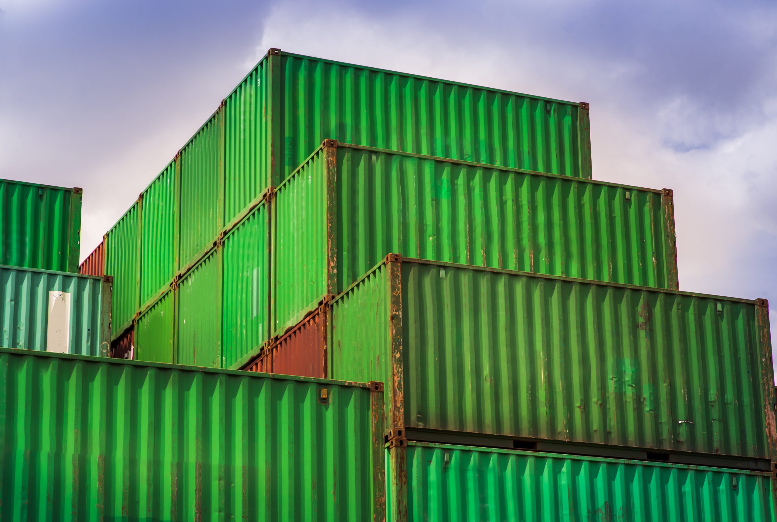 A cargo port import export wharf, connections with all around the world in international trade businesses. Port cranes, THC, containers waiting to leave.